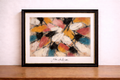 Framed abstract expressionist painting on wall